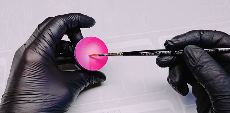 Applying fluorescent paint with a brush